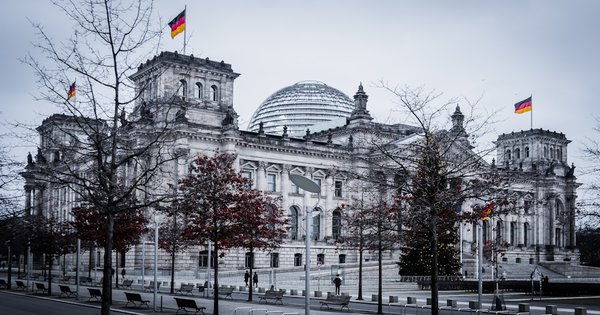 The German Reichstag building in Berlin, home of the Bundestag, under a blue sky